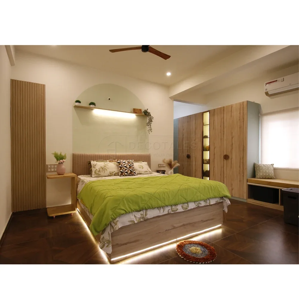 Decotales villa bedroom with wood storage and a green bedspread