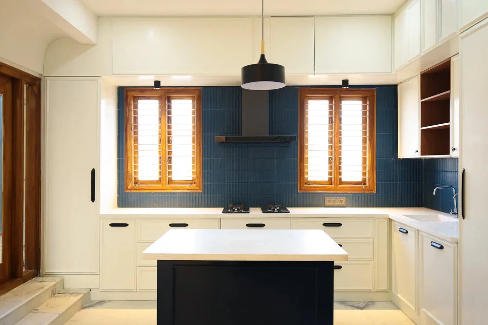 Decotales villa kitchen with an island, ivory cabinetry and blue backsplash